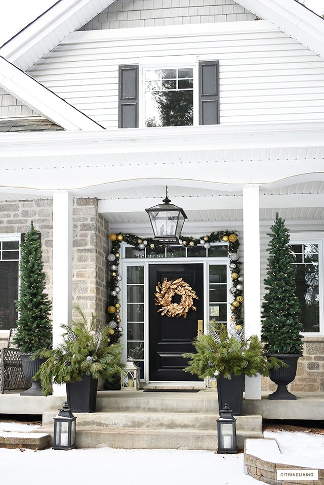 Black Front Door with Golden Wreath and Flanking Evergreen Trees Black Front Door with Golden Wreath and Flanking Evergreen Trees — Christmas Front Door Decor