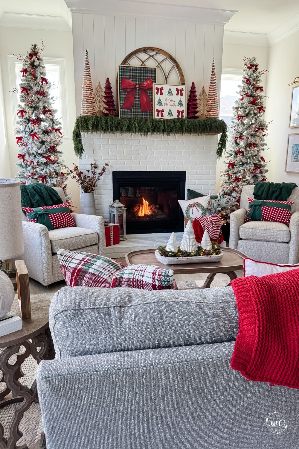 Traditional Living Room with Symmetrical Flocked Christmas Trees by the Fireplace — Christmas Living Room Decor