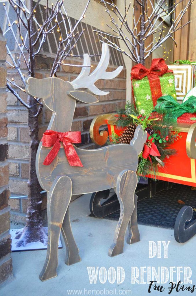 Rustic DIY Wood Reindeer Beside a Red Sleigh with Gifts Rustic DIY Wood Reindeer Beside a Red Sleigh with Gifts — Christmas Yard Decor