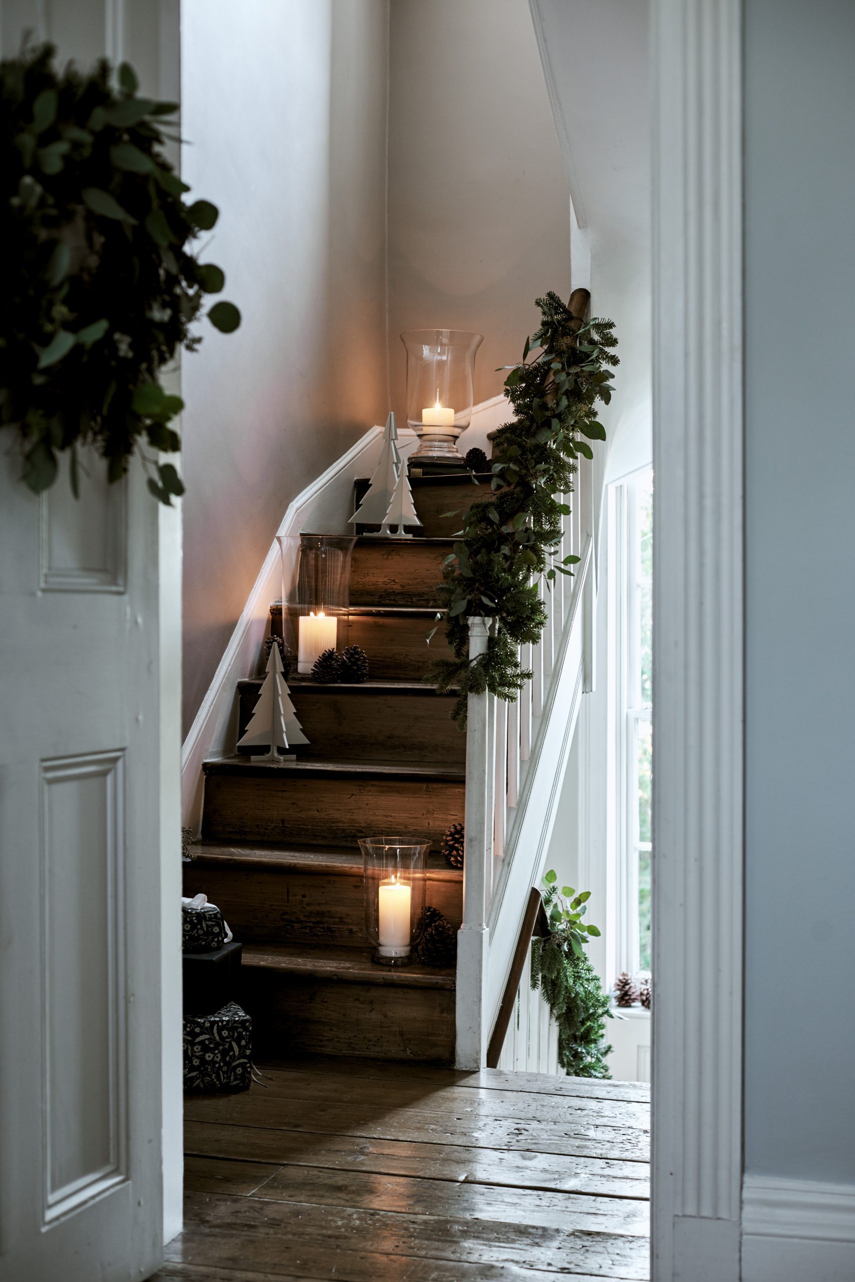 Minimalist Staircase with LED Candles and Small Trees on Steps Minimalist Staircase with LED Candles and Small Trees on Steps — Christmas Staircase Decor