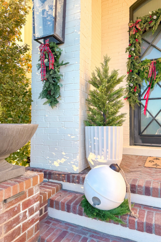 Traditional Porch with White Brick, Lanterns, and Coordinated Holiday Decor — Christmas Porch Lanterns