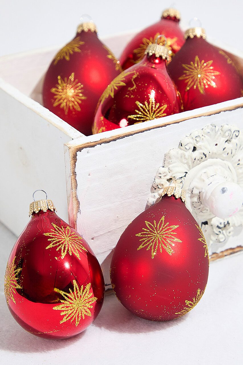 Close-up of Red Glass Ornaments with Gold Starburst Designs Close-up of Red Glass Ornaments with Gold Starburst Designs — Red and Gold Christmas Decor