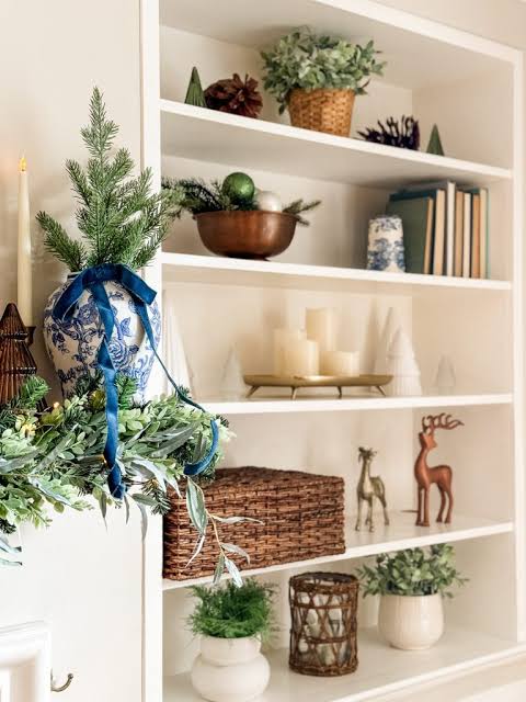 Elegant White Bookshelf with Greenery and Gold Accents Elegant White Bookshelf with Greenery and Gold Accents — Christmas Bookshelf Decor