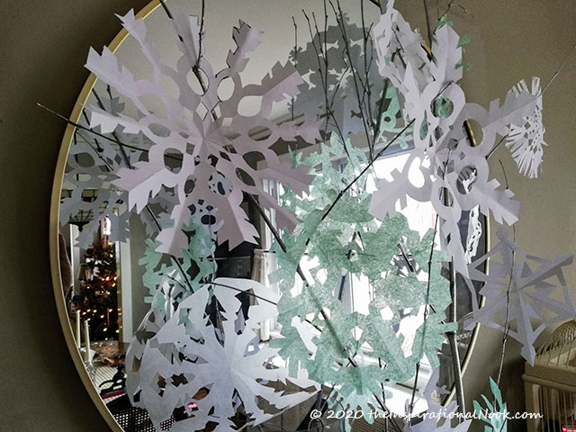 Paper Snowflakes and Branches Around a Mirror