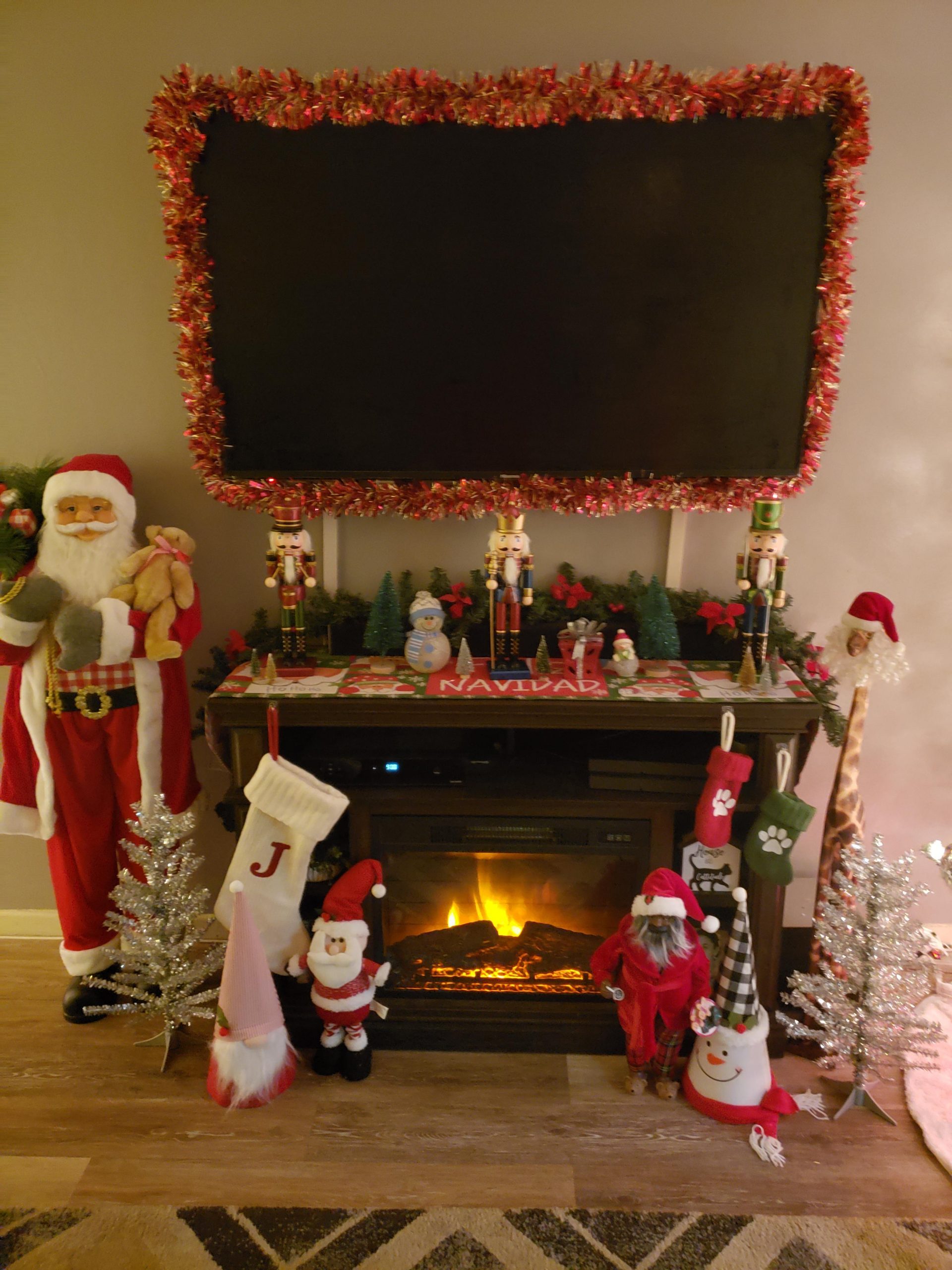 Eclectic Fireplace Mantel with Santa Figures — Christmas Apartment Decor
