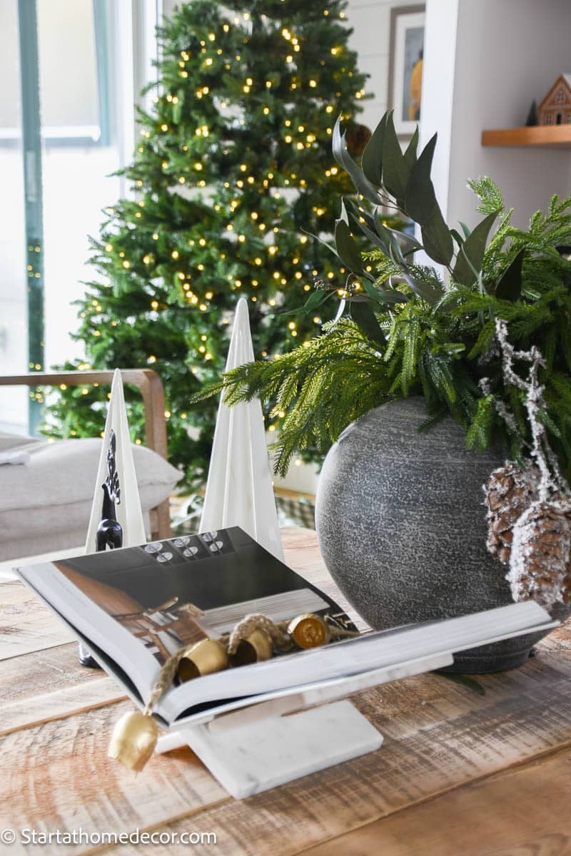 Modern Rustic Coffee Table with Open Book and Greenery Modern Rustic Coffee Table with Open Book and Greenery — Christmas Coffee Table Decor