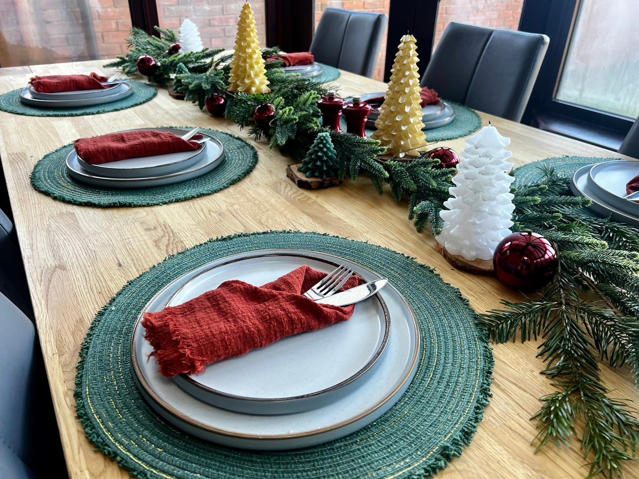 Modern Dining Table with Green Placemats and Beeswax Candles — Christmas Dining Room Decor