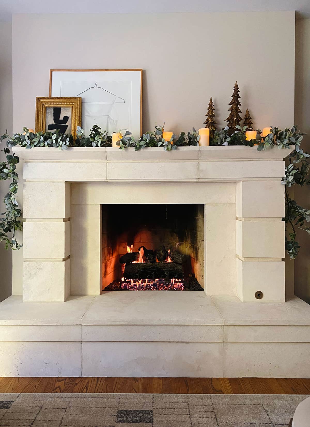 Traditional Mantel with Abundant Garland and Lit Christmas Tree — Christmas Mantel Decor