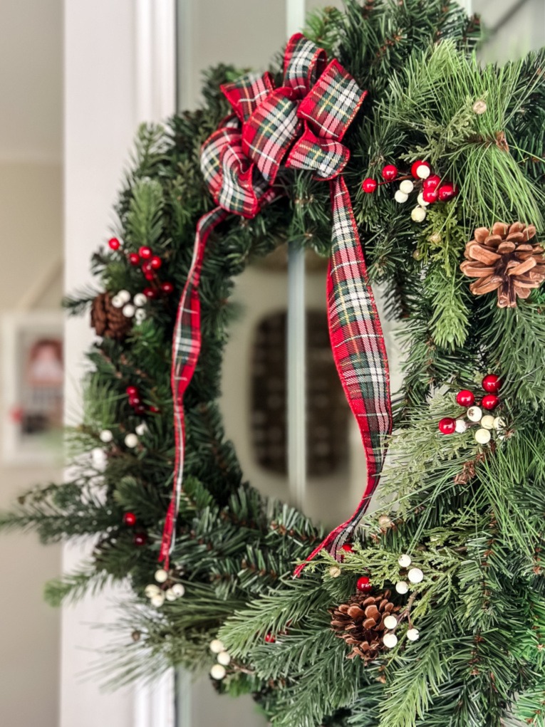 Traditional Pine Wreath with Plaid Ribbon on an Interior Door Traditional Pine Wreath with Plaid Ribbon on an Interior Door — Christmas Wreath