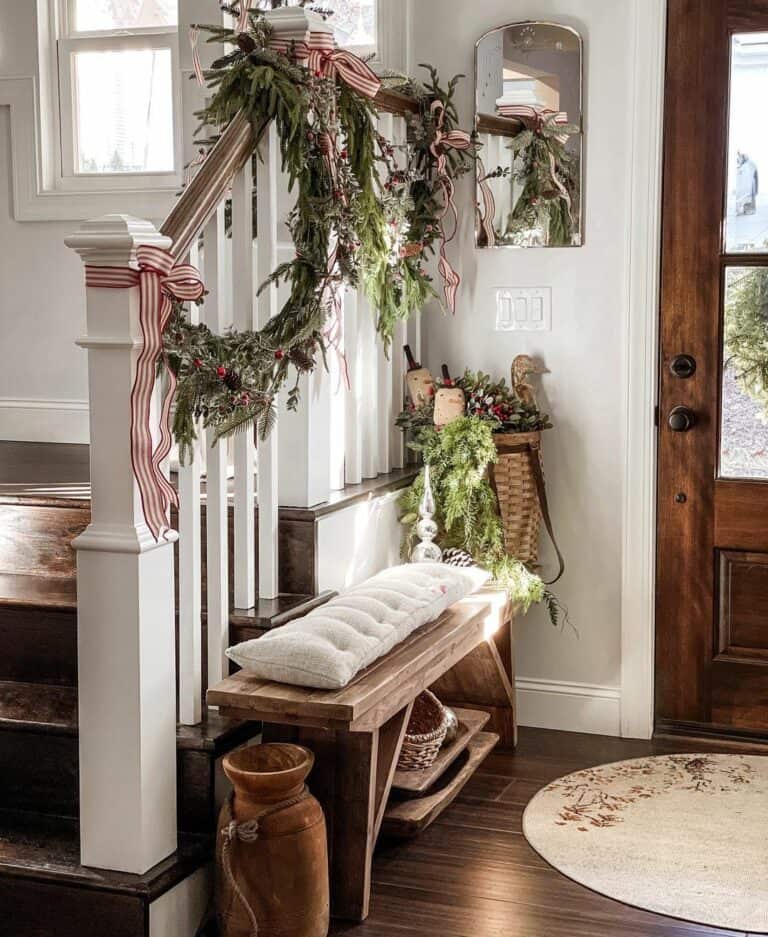 Farmhouse White Staircase with Garland, Red/White Ribbons, and Bench Farmhouse White Staircase with Garland, Red/White Ribbons, and Bench — Christmas Staircase Decor