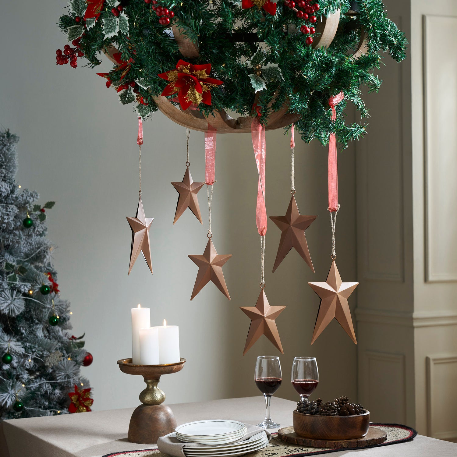 Chandelier Dressed in Greenery and Bronze Stars — Rustic Christmas Decor