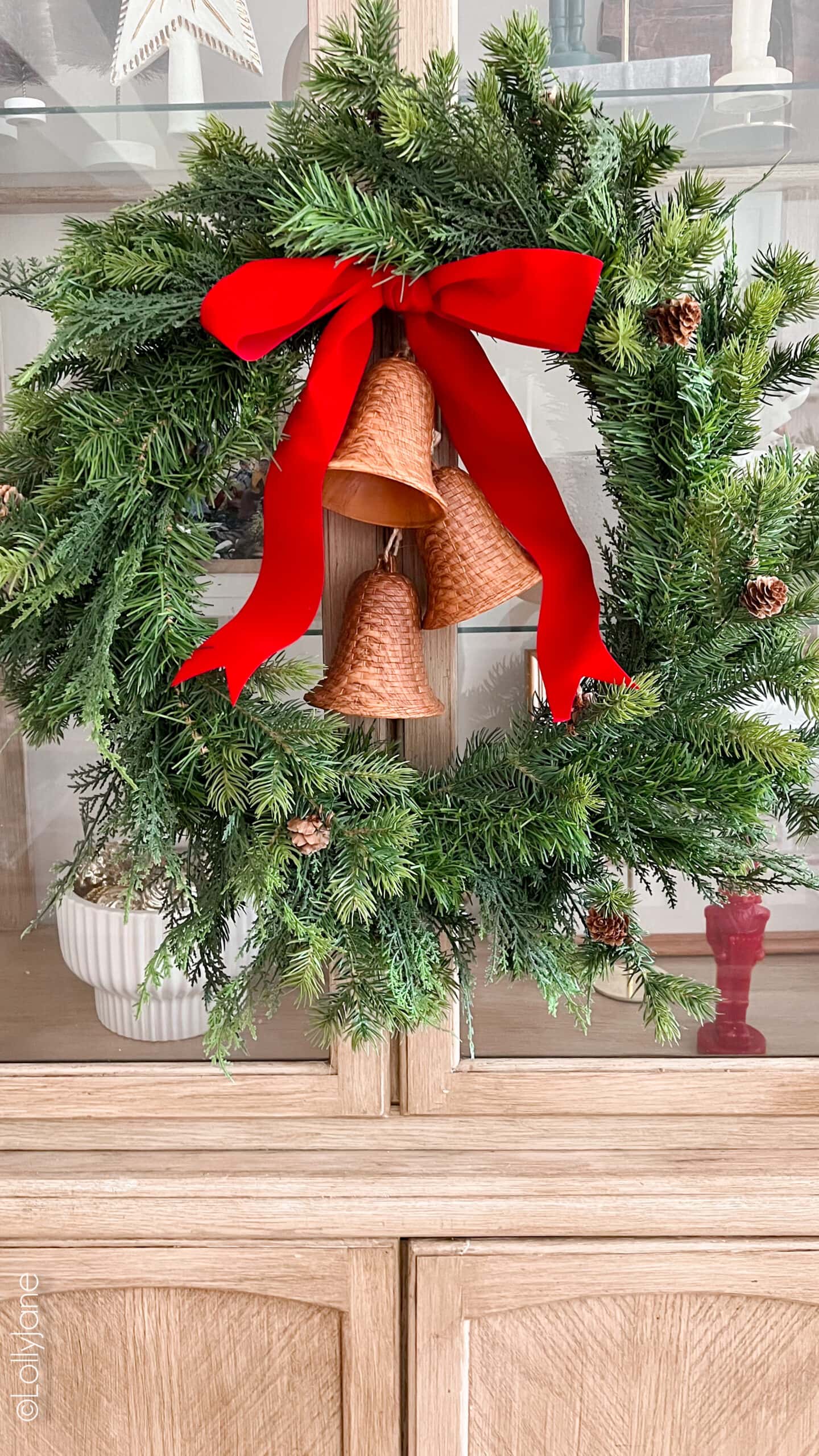 Traditional Pine Wreath with Golden Bells on Cabinet Traditional Pine Wreath with Golden Bells on Cabinet — DIY Christmas Wreath