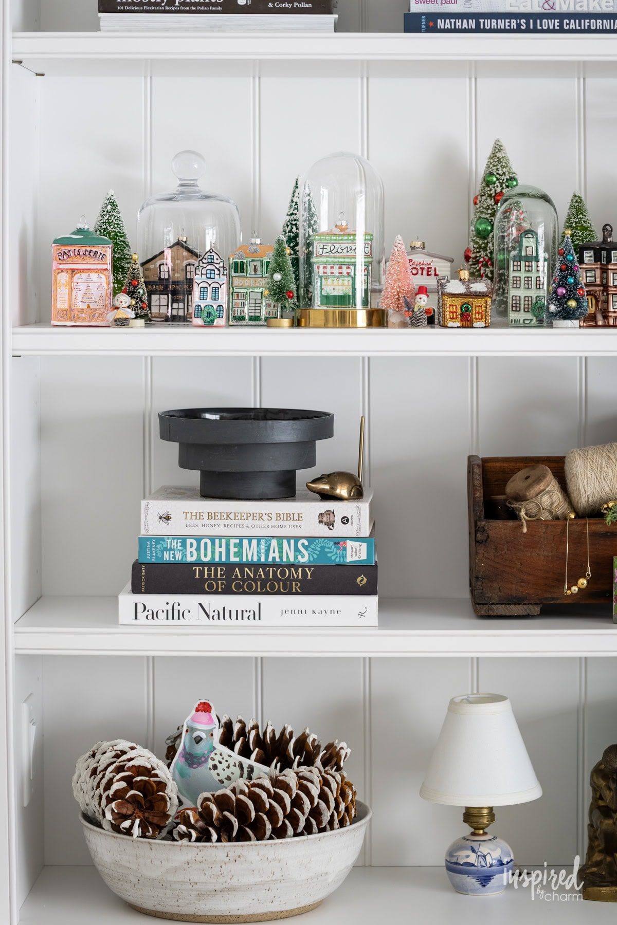 Bookshelf Featuring a Miniature Christmas Village Scene Bookshelf Featuring a Miniature Christmas Village Scene — Christmas Bookshelf Decor
