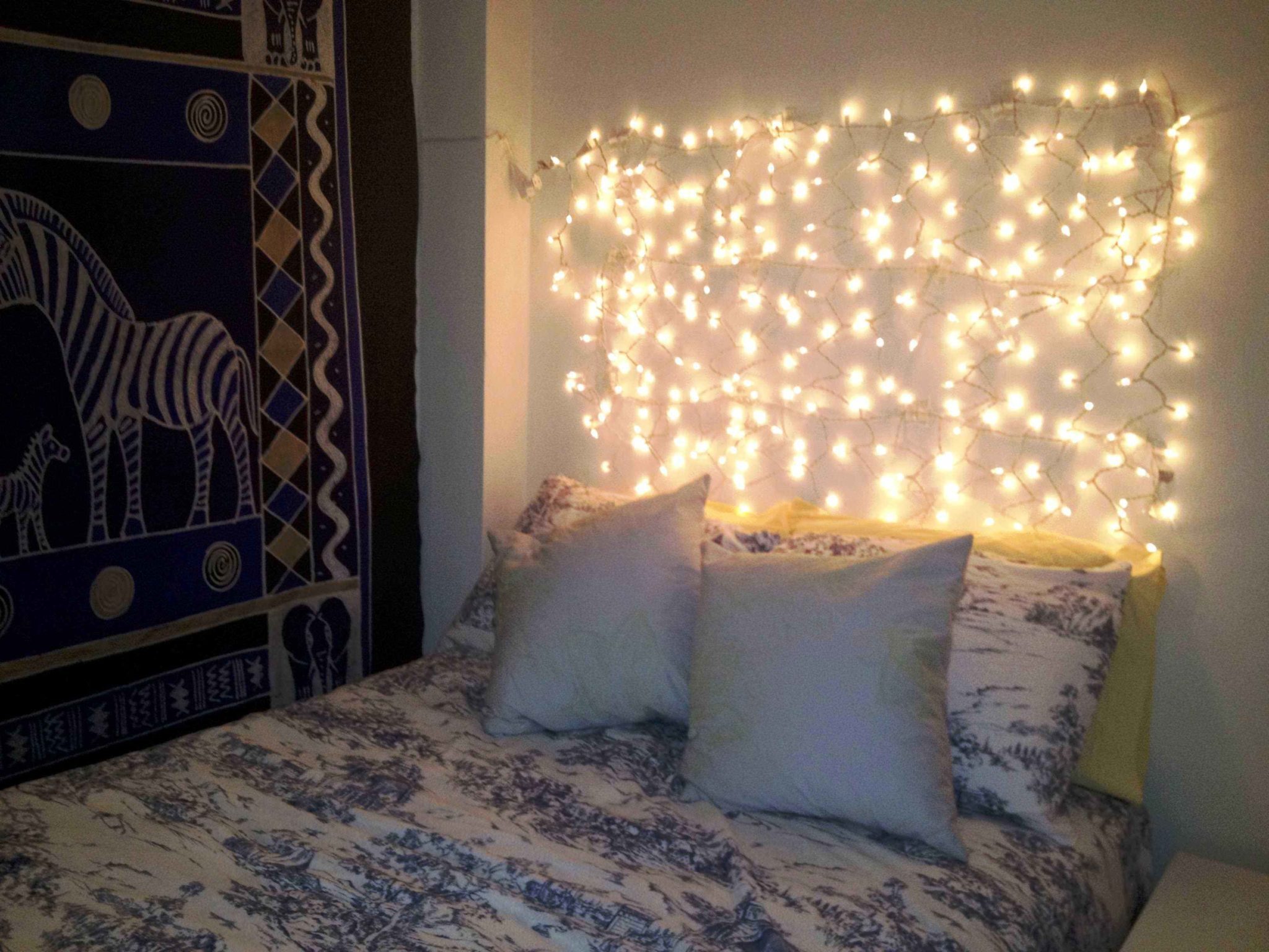 Boho Bedroom with Dense Fairy Light Arrangement and Gingham Bedding — Christmas Fairy Lights Headboard