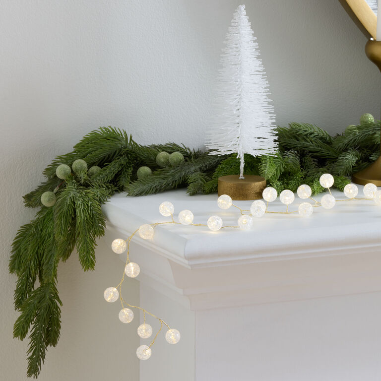 Modern Garland with Orb-Shaped Lights on Fireplace Mantel Modern Garland with Orb-Shaped Lights on Fireplace Mantel — Christmas Lights in Garland Indoor