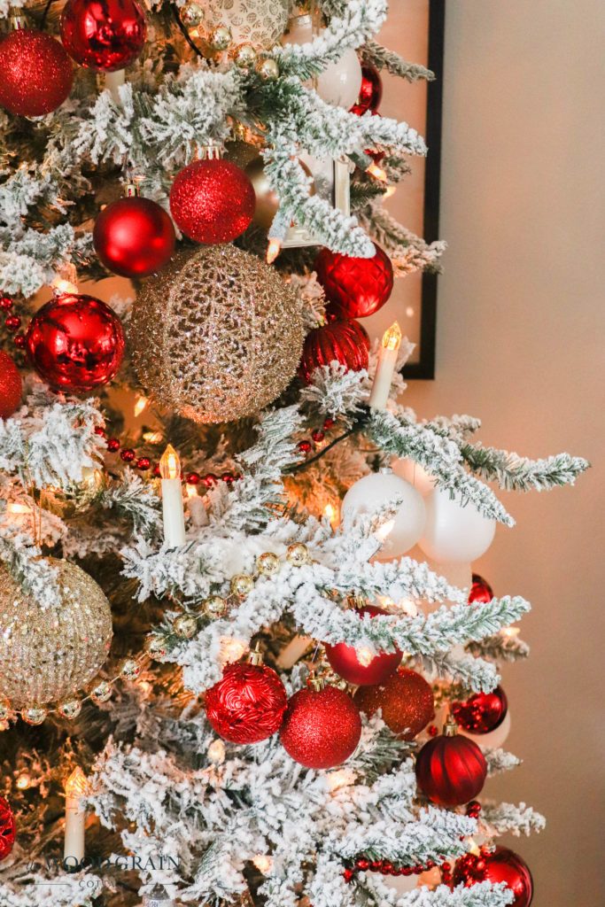 Close-up of a Flocked Tree with Red and Gold Baubles Close-up of a Flocked Tree with Red and Gold Baubles — Red and Gold Christmas Decor