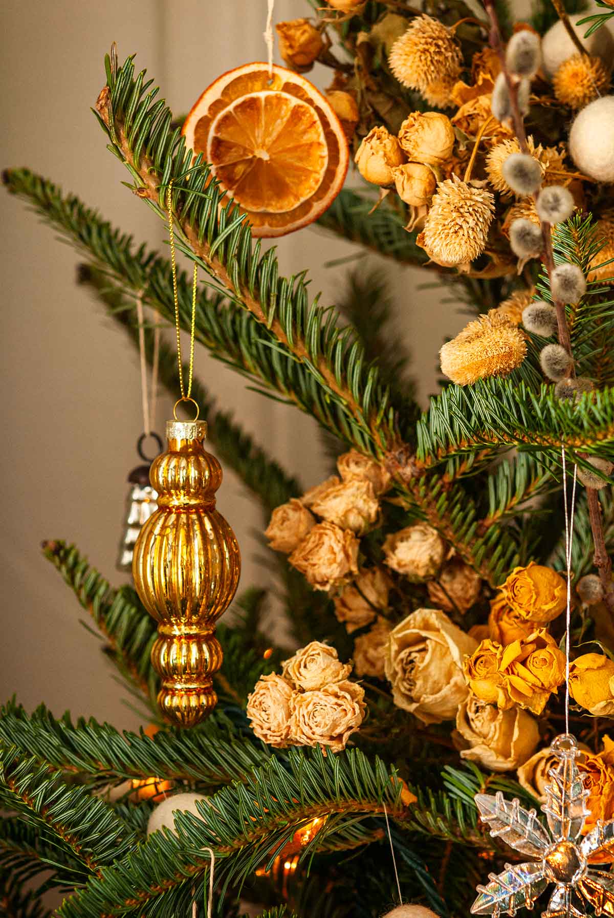 Add a vintage gold bauble with natural elements to a tree branch Add a vintage gold bauble with natural elements to a tree branch — Gold Christmas Decor