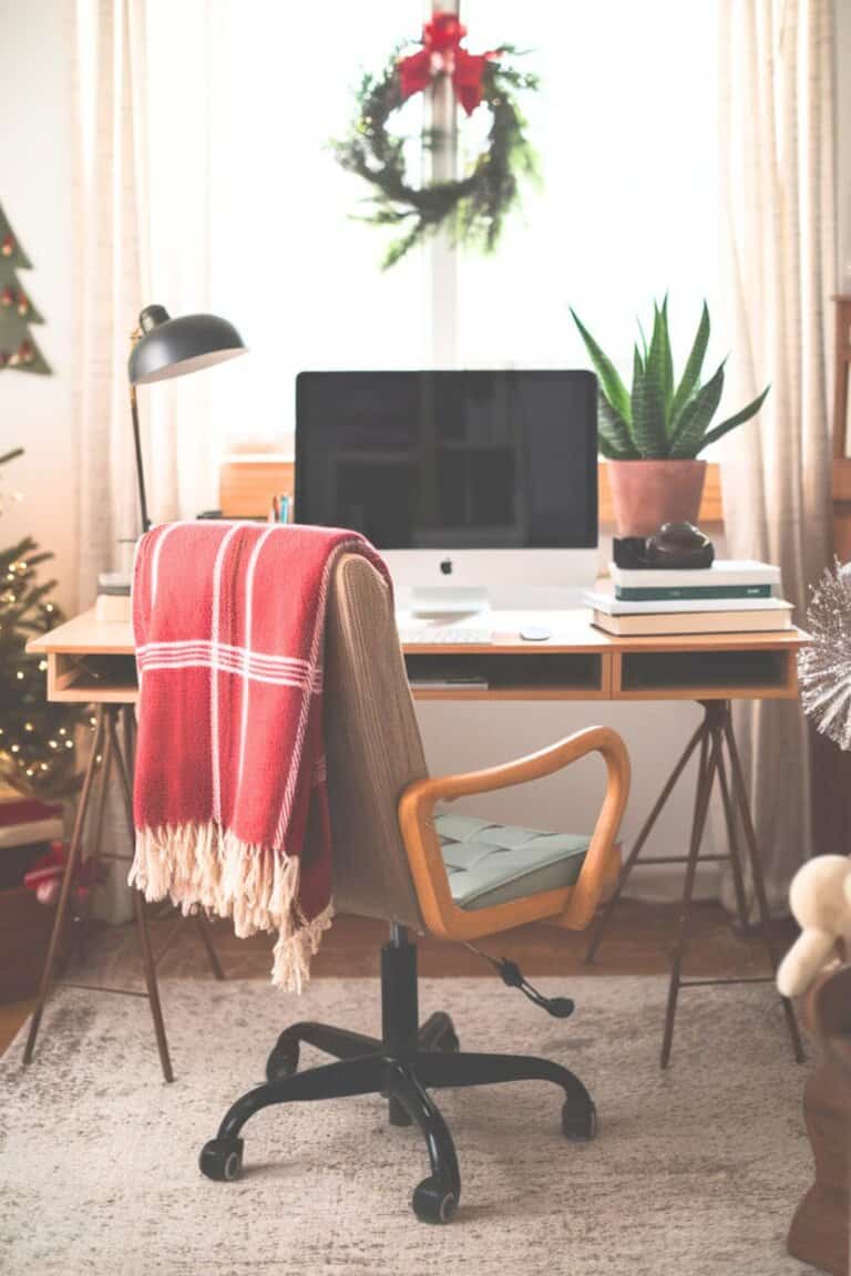 Cozy Desk with Festive Red Throw and Small Tree Cozy Desk with Festive Red Throw and Small Tree — Christmas Home Office Decor