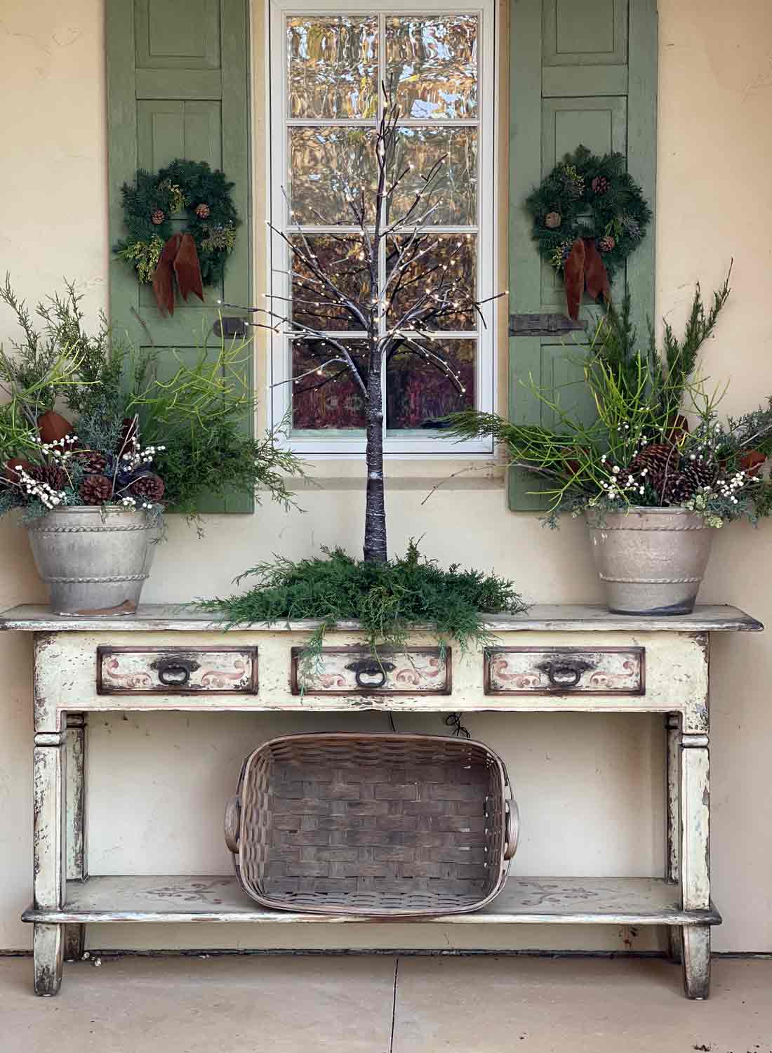 Rustic Console Table Vignette with a Small Lit Tree and Potted Greenery — Simple Christmas Outdoor Decor
