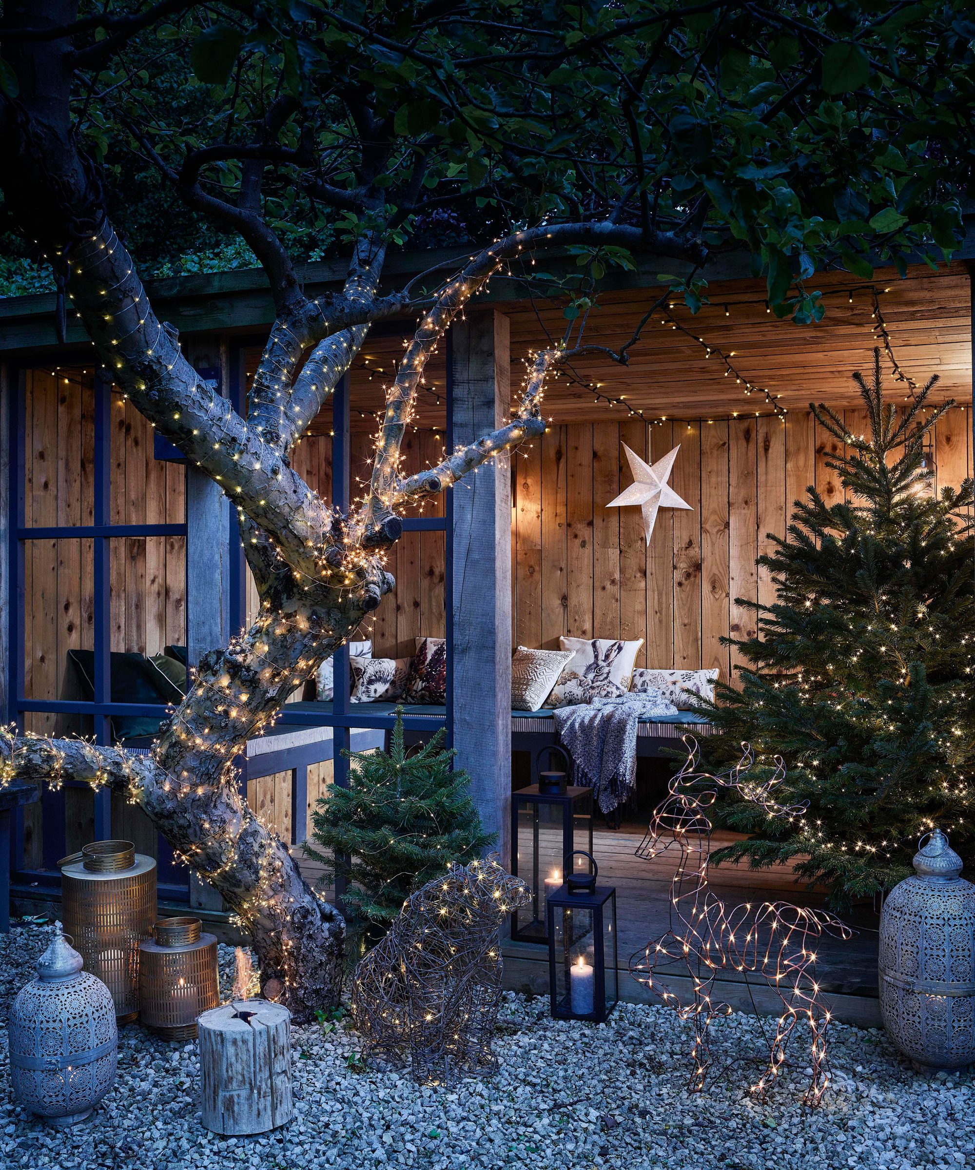 Rustic Outdoor Room with Whimsical Reindeer and Tree Lights Rustic Outdoor Room with Whimsical Reindeer and Tree Lights — Outdoor Christmas Lights