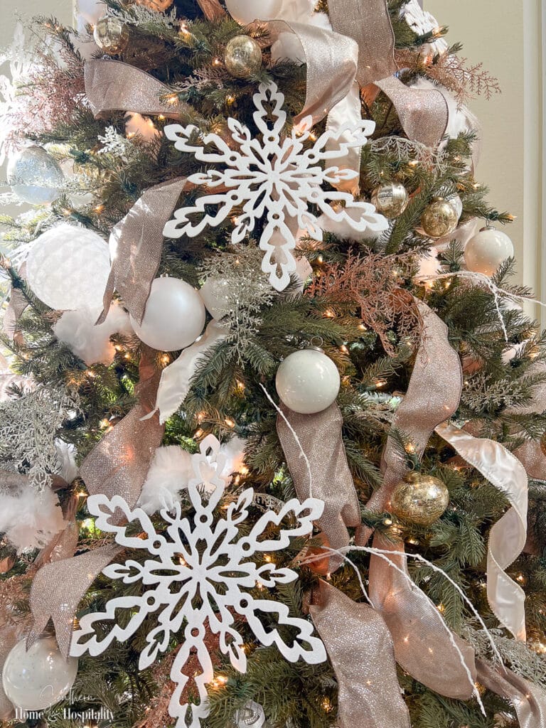 Elegant Christmas tree details with white snowflakes and rose gold ribbon Elegant Christmas tree details with white snowflakes and rose gold ribbon — Gold and White Christmas Tree