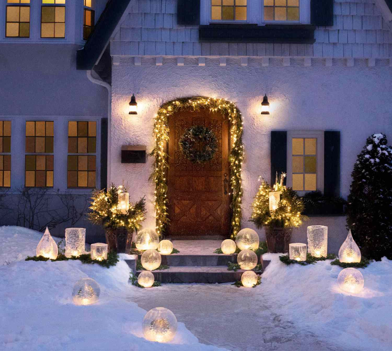 Elegant Entryway with Glowing Orbs and Lit Doorway — Christmas House Exterior Decor