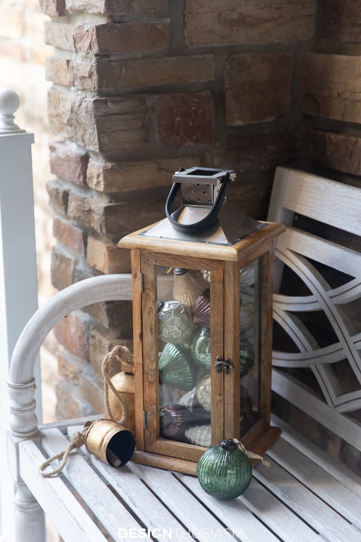 Rustic Wooden Lantern Filled with Ornaments on a White Bench — Christmas Porch Lanterns