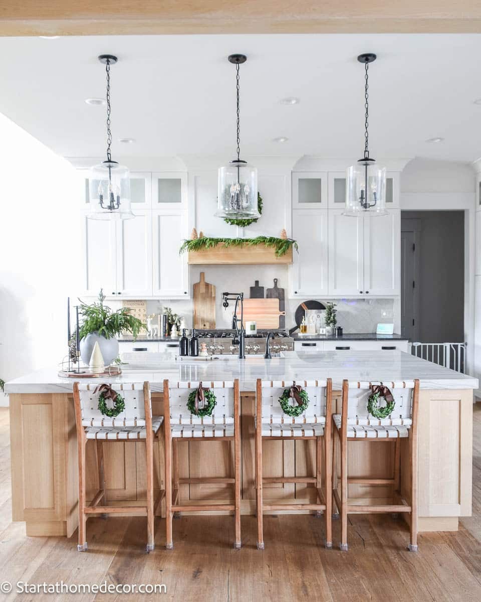 Farmhouse Kitchen Island with Bar Stools Adorned with Wreaths — Farmhouse Christmas Kitchen
