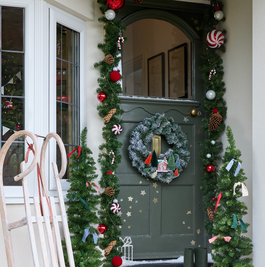 Whimsical Green Door with Frosted Wreath and Miniature House Ornament Whimsical Green Door with Frosted Wreath and Miniature House Ornament — Christmas Front Door Decor