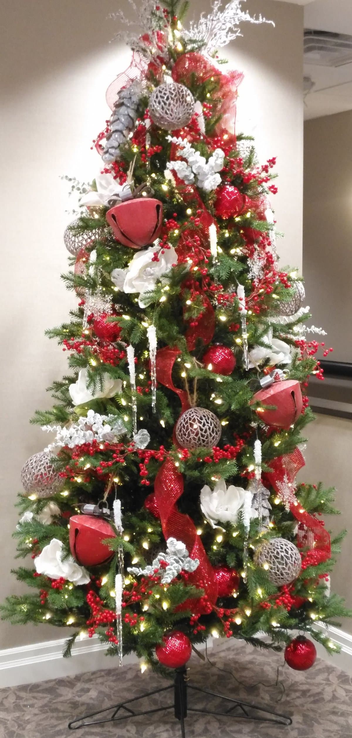 Eclectic Christmas Tree Detail with Large Red Bells and Icicle Decorations Eclectic Christmas Tree Detail with Large Red Bells and Icicle Decorations — Red and White Christmas Tree