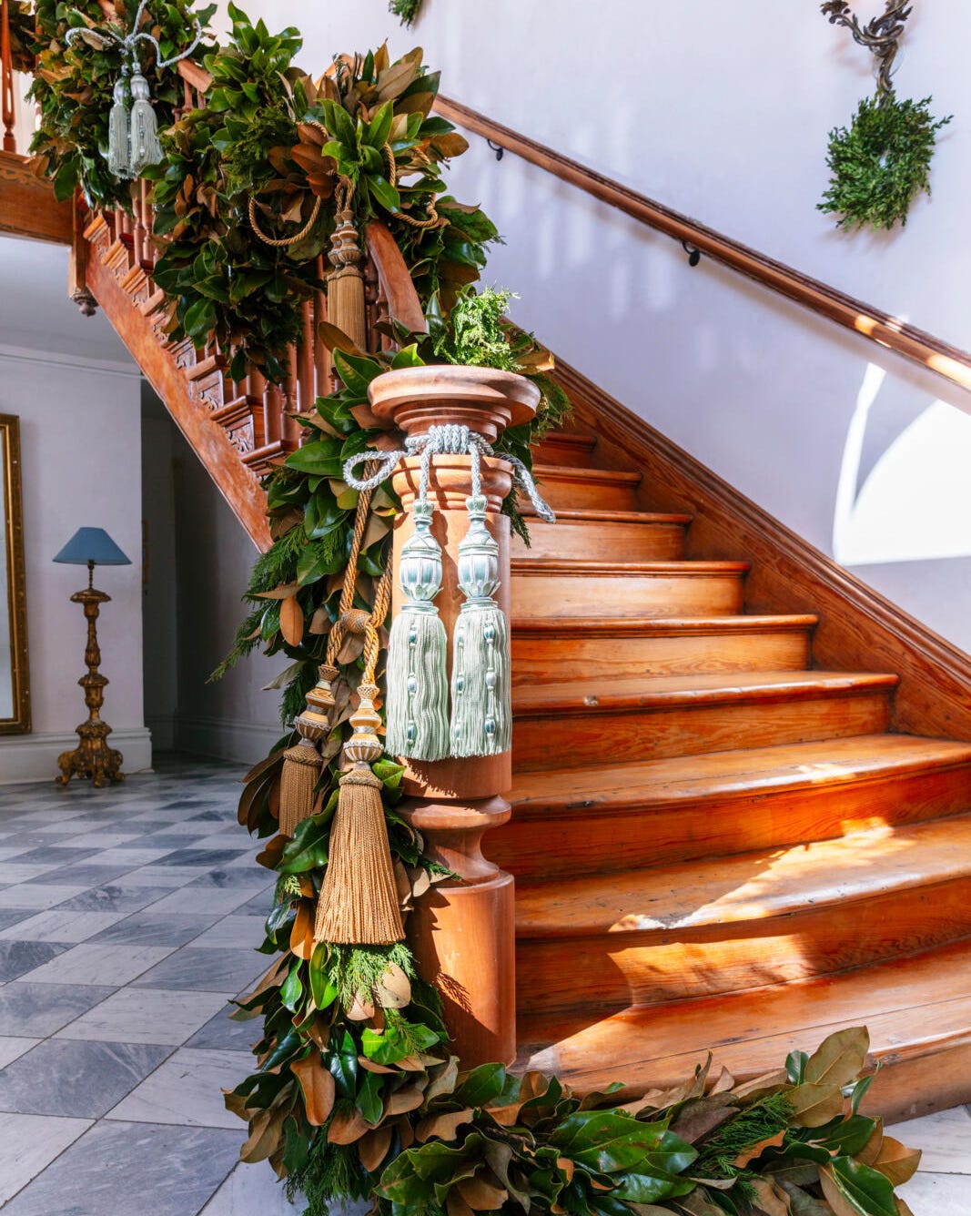 Grand Wooden Staircase with Magnolia Leaf Garland and Tassels Grand Wooden Staircase with Magnolia Leaf Garland and Tassels — Christmas Staircase Decor