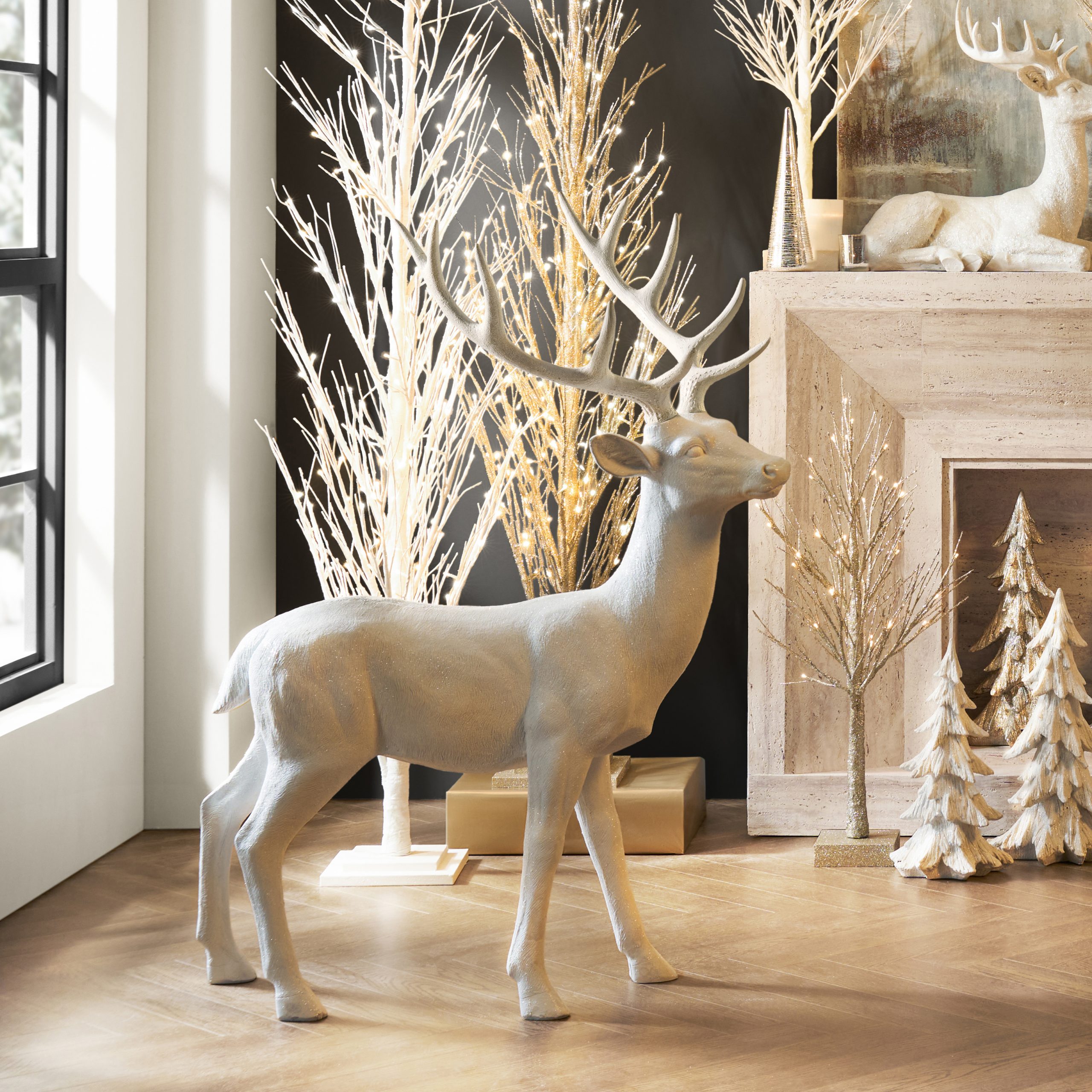 Chic Modern Vignette with Large White Decorative Deer and Illuminated Branches — Modern Christmas Decor