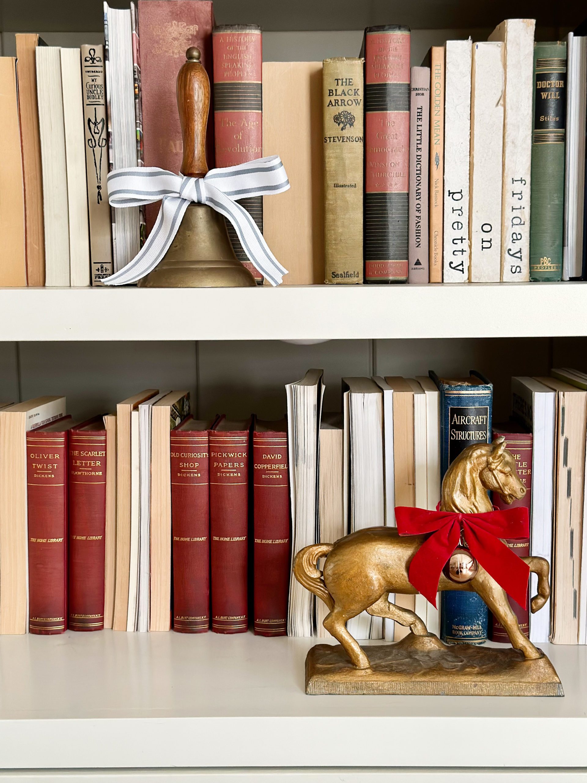 Bookshelf with Vintage Bell and Festive Horse Figurine Bookshelf with Vintage Bell and Festive Horse Figurine — Christmas Bookshelf Decor