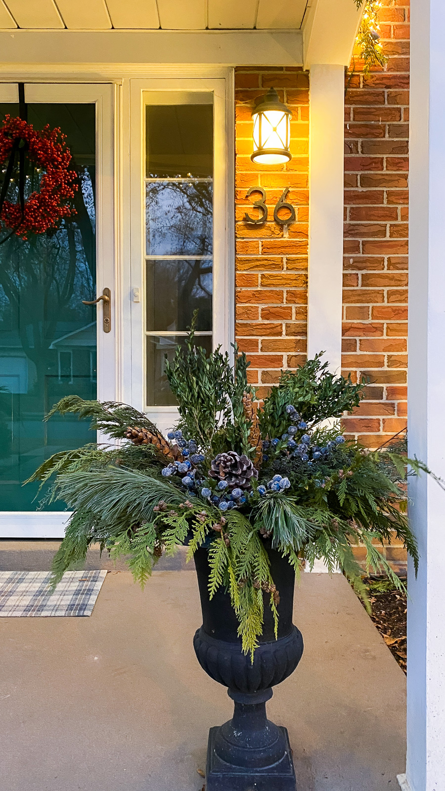 Lush Evergreen Arrangement in a Large Black Urn Planter Lush Evergreen Arrangement in a Large Black Urn Planter — Christmas Porch Planters