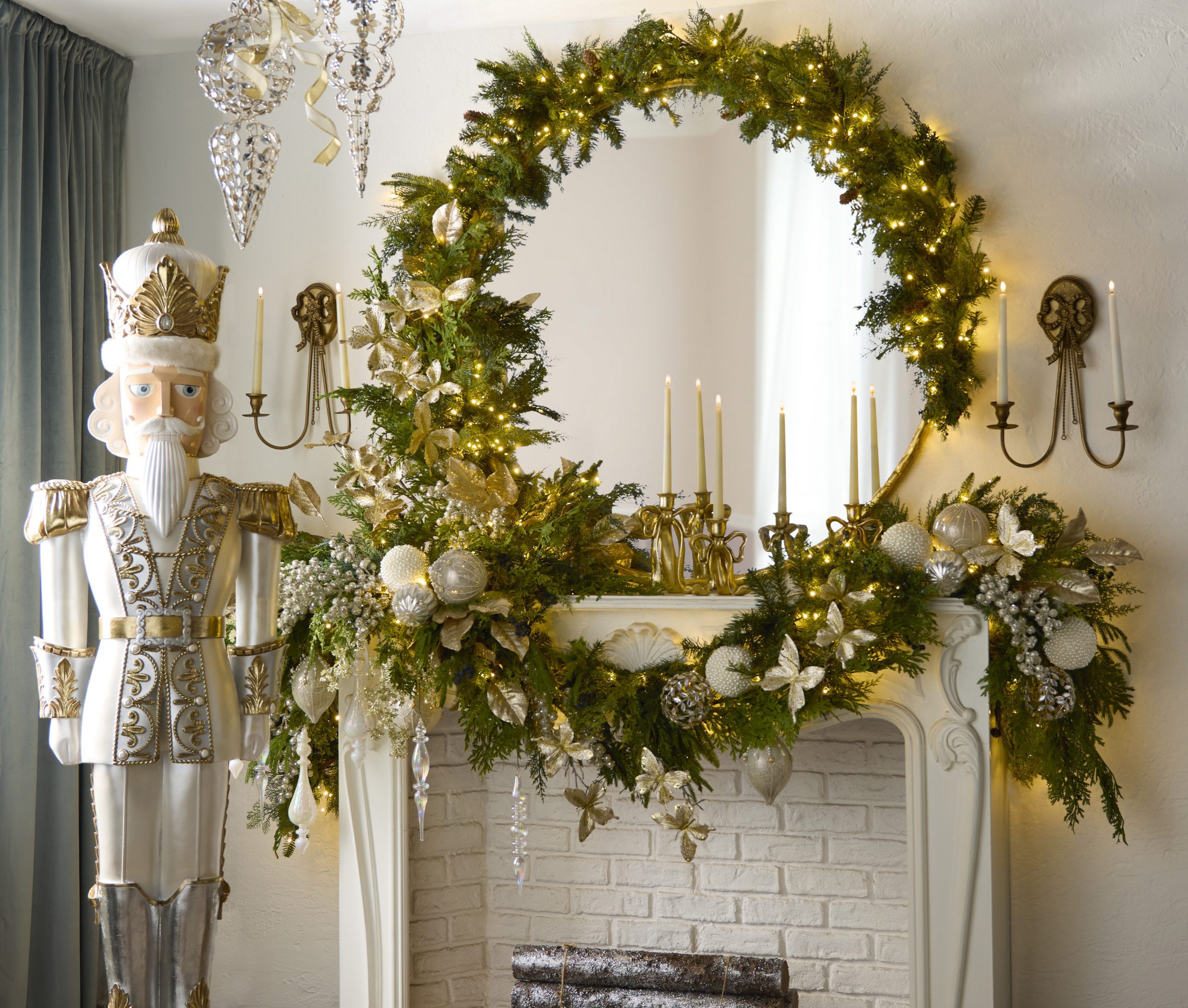 White Brick Mantel with Lush Garland and Oversized Nutcracker — Christmas Mantel Decor