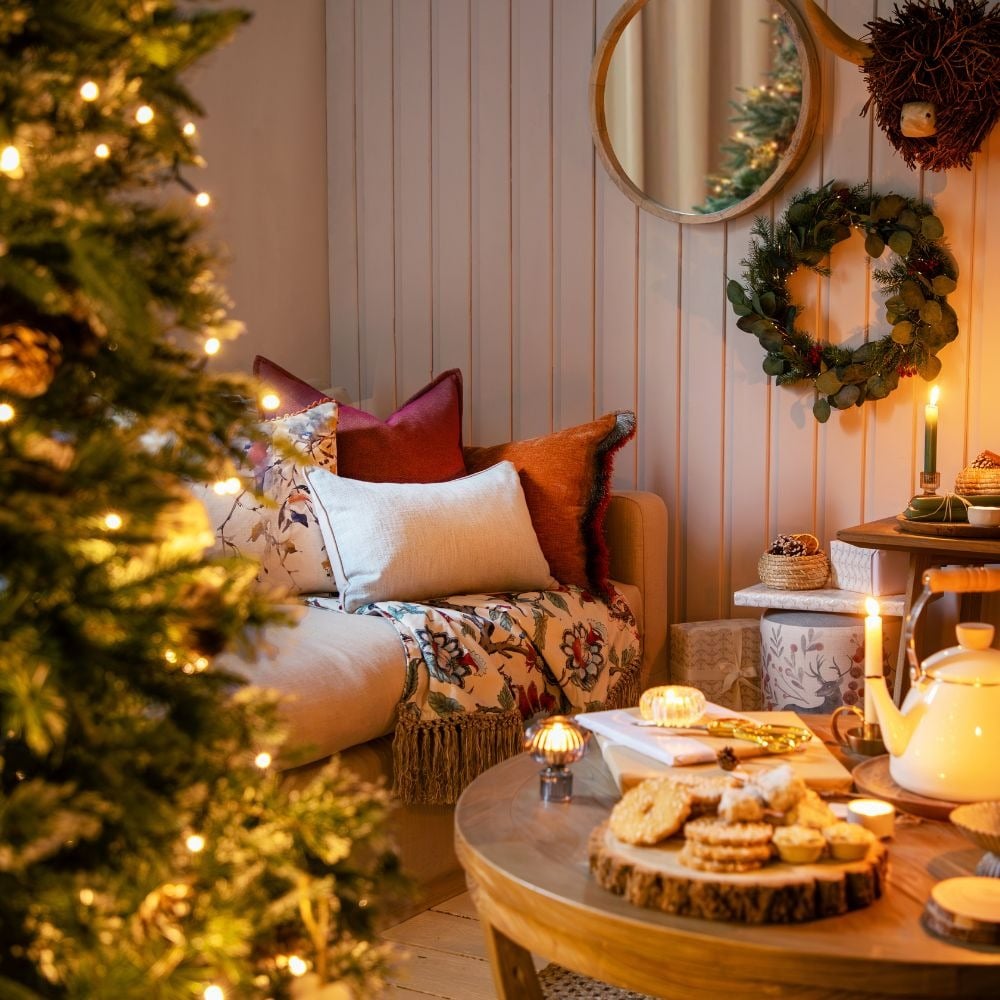 Cozy Living Room Corner Vignette with Textured Pillows and Festive Treats — Christmas Living Room Decor