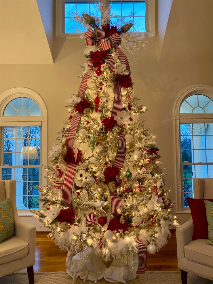 Elegant White Flocked Tree with Luxurious Red Ribbon and White Floral Accents Elegant White Flocked Tree with Luxurious Red Ribbon and White Floral Accents — Red and White Christmas Tree