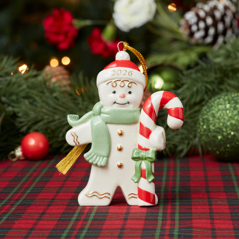 Snowman Ornament Holding a Candy Cane on a Plaid Tablecloth — Candy Cane Christmas Decor