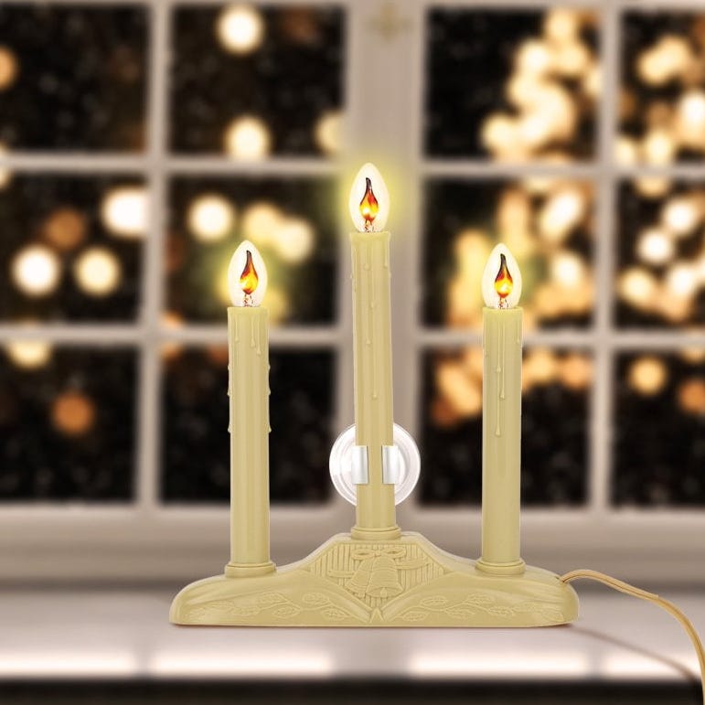 Flickering LED Tapers Against Bokeh Lights — Christmas Window Candles