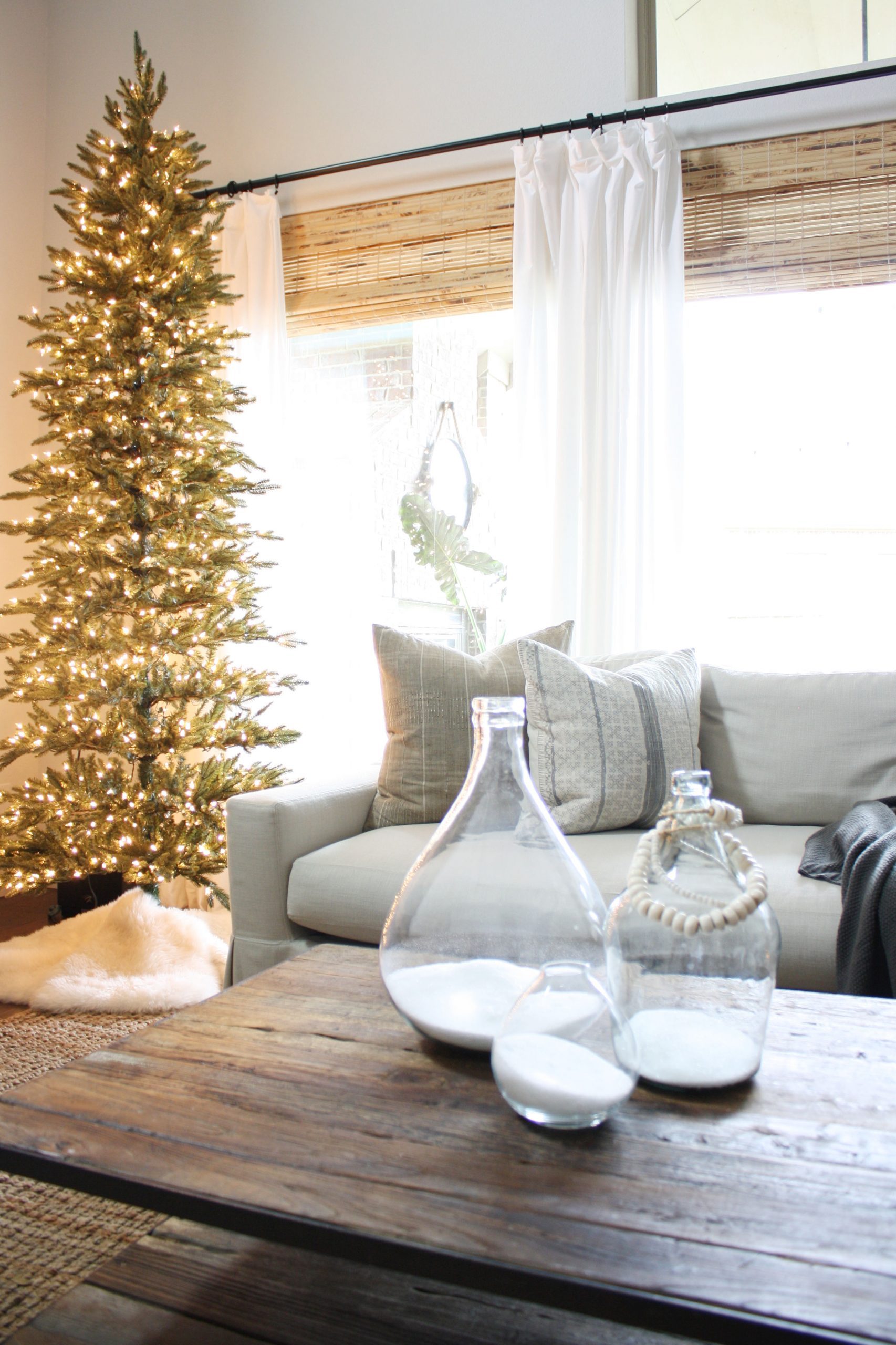 Airy Living Space with Fully Lit Central Tree and Faux Fur Rug — Minimalist Christmas Tree
