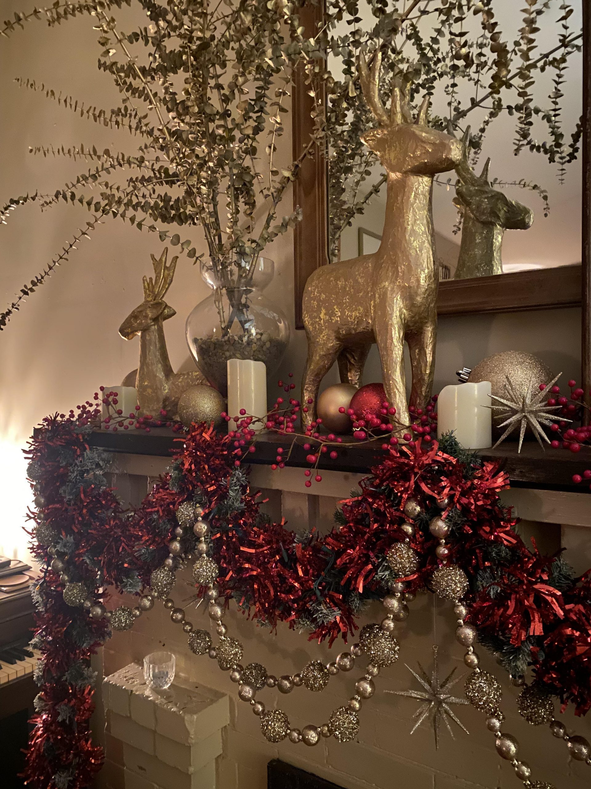 Fireplace Mantel with Gold Reindeer and Red and Gold Ornaments Fireplace Mantel with Gold Reindeer and Red and Gold Ornaments — Red and Gold Christmas Decor