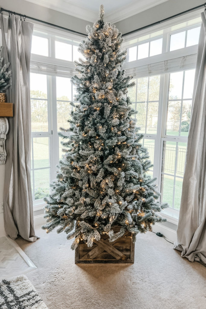 Farmhouse White Tree in Rustic Wooden Collar by a Window Farmhouse White Tree in Rustic Wooden Collar by a Window — White Christmas Tree Decor