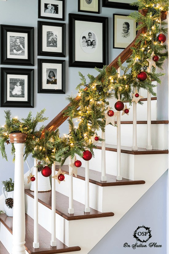Pine Garland with Red Ornaments, Wooden Stars, and Twinkling Lights Pine Garland with Red Ornaments, Wooden Stars, and Twinkling Lights — Christmas Staircase Decor