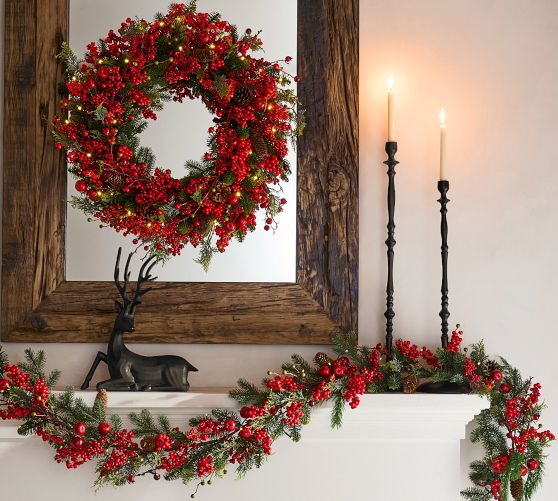Elegant Wreath with Berries and Pinecones Above a Rustic Mirror Elegant Wreath with Berries and Pinecones Above a Rustic Mirror — Christmas Wreath
