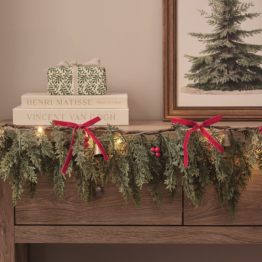 Faux Pine Garland with Velvet Bows and Gold Bells on a Shelf Faux Pine Garland with Velvet Bows and Gold Bells on a Shelf — Christmas Garland