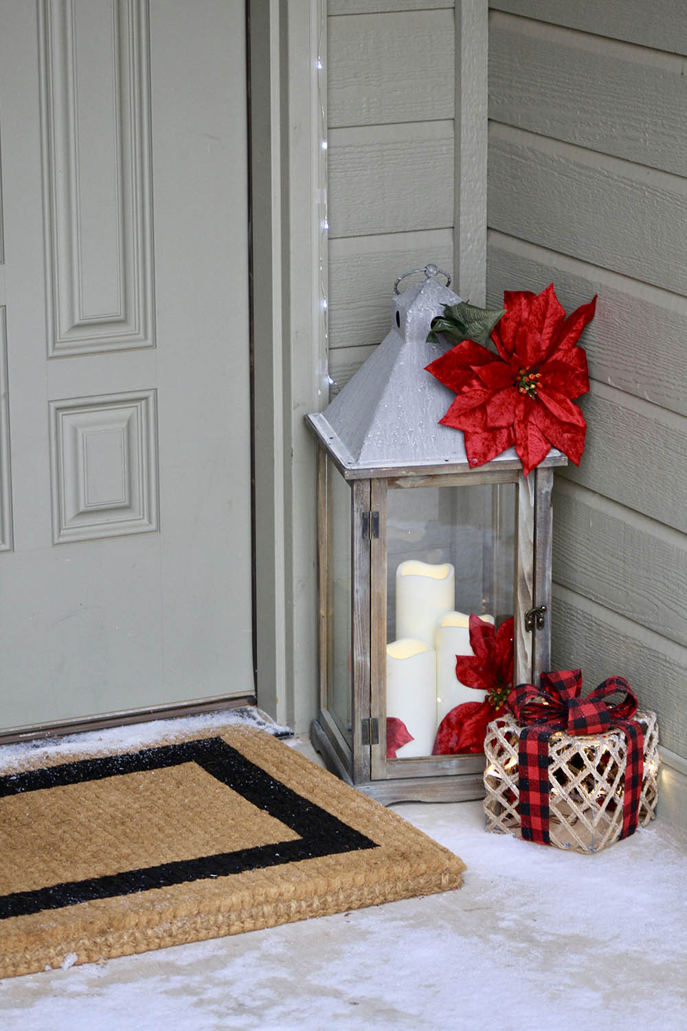 Festive Lantern with Faux Candles and Poinsettias on a Snowy Porch — Christmas Porch Lanterns
