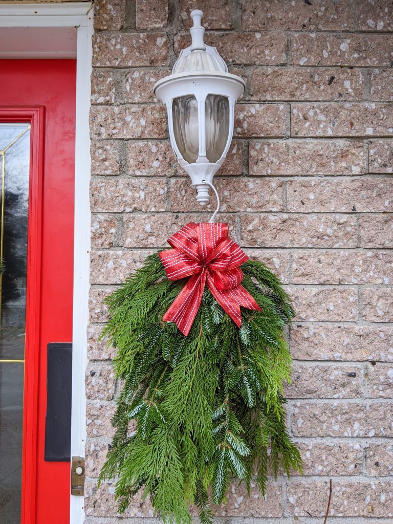 Traditional White Wall Lantern Paired with a Red Bow Wreath — Christmas Porch Lanterns