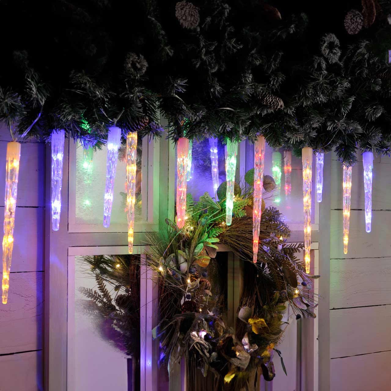 Multicolor Icicle Lights on Covered Porch Evergreen — Icicle Christmas Lights