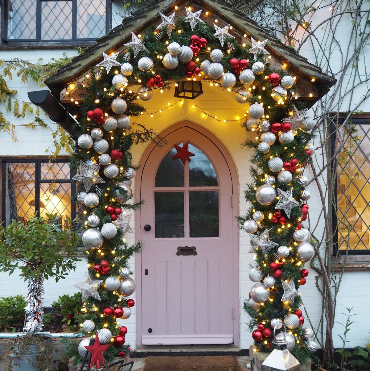 Whimsical Door Frame Drenched in Festive Ornaments and Lights — Christmas Door Frame Lights