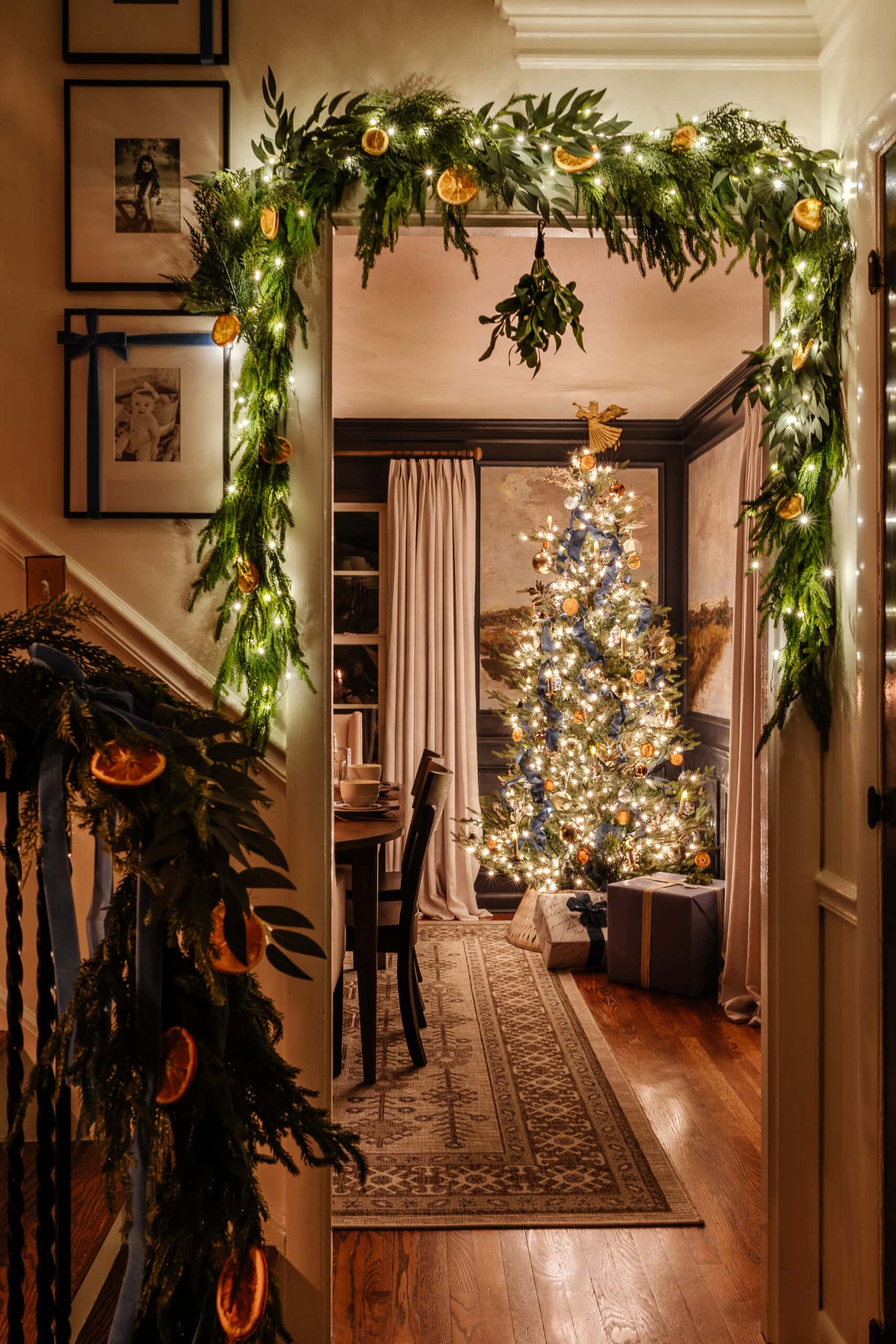 Cozy Archway Framed with Lit Greenery and Dried Oranges — Christmas Door Frame Lights